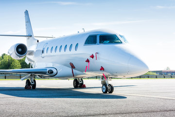 Naklejka premium White private business jet at the parking lot of airport