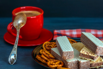 chocolate wafers and coffee on a dark background 