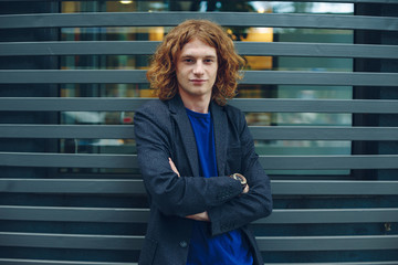Portrait of red haired man over urban futuristic background