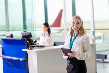 Young Ground Staff Holding Digital Tablet At Airport