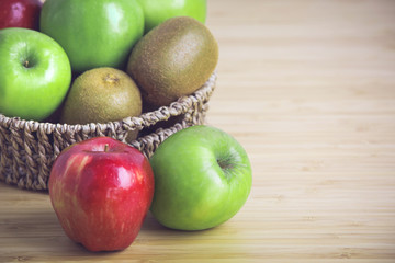 Fresh kiwi, apples on wooden background