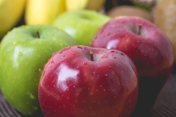Green and red of apples on  black background