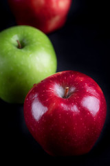 Green and red of apples on  black background