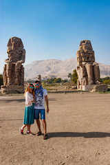Couple near the ruins of statues in Luxor, Egypt