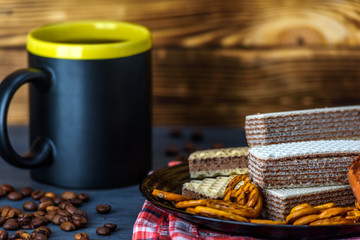 chocolate wafers and coffee on a dark background 