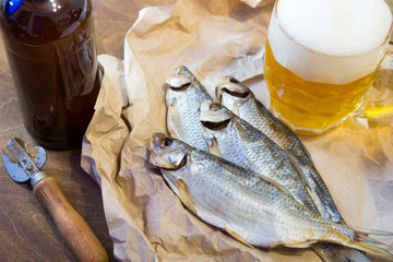 Traditional Russian snacks to beer. Dried roach on paper.