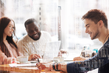 Close up of optimistic man spending time his friends