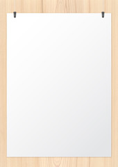 White paper and holding clips on wooden background