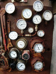 A whole lot of measuring instruments on a rusty plate