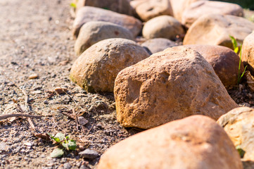 border of stones near the walkway. nature, peace.