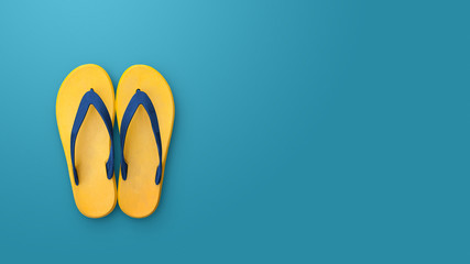 Flip flops isolated on blue background. Top view and copy space. Slippers yellow