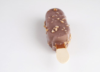 Ice cream covered with chocolate and almonds on white background