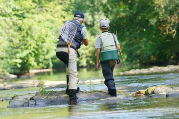 Papier Peint photo autocollant Pêcher Back view of father and son fly fishing in river