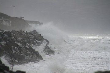 Fototapeta na wymiar Stormy seas crashing over railway station - near Barmouth