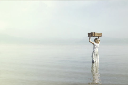 dreamer woman walking towards the infinite in the sea