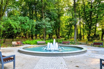 Nice fountain in the urban park. Green park in the city of Chrzanow, Poland.