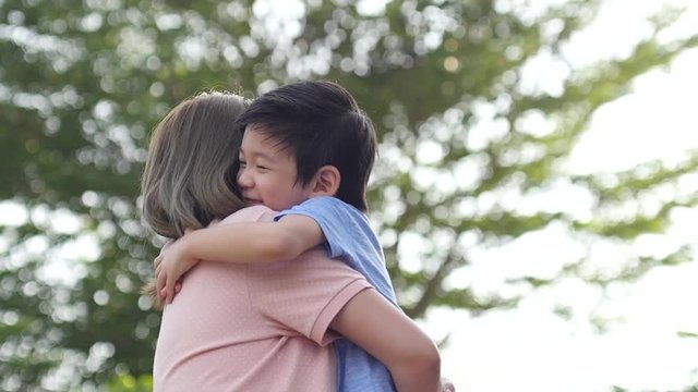 Asian mother and her son playing in the park,slow motion4