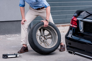 man changing car tire