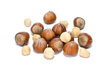 Whole and peeled hazelnuts isolated on white