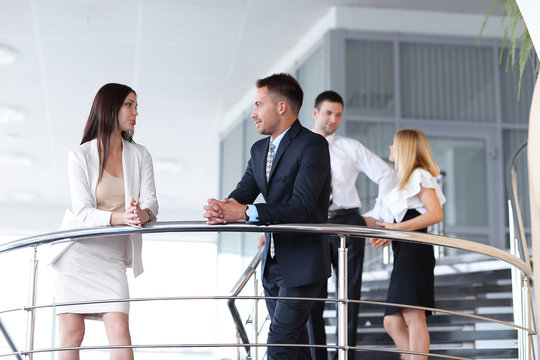 Business People Having Break And Talking On Terrace Of Office Building.