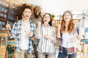 Successful colleagues raising fists up