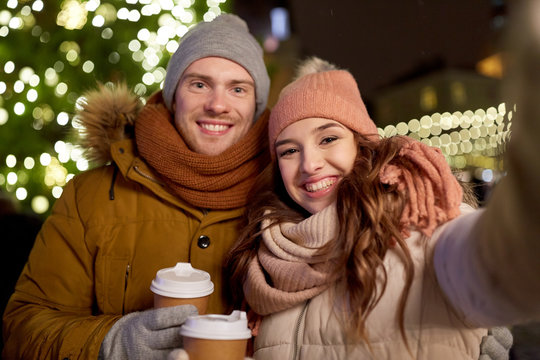 couple with coffee taking selfie at christmas - Powered by Adobe