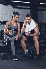 sportive couple with smartphone