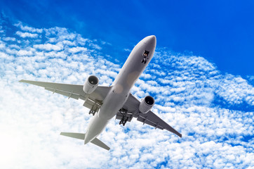 Fototapeta na wymiar White big passenger airplane in the blue sky.