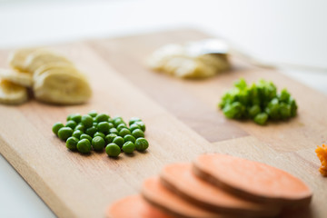 peas and other vegetables on wooden board