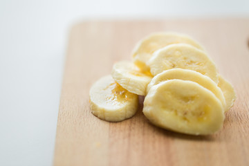 close up of banana on wooden cutting board