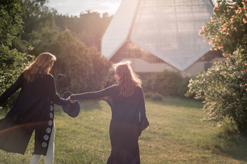 Mom and daughter against the glass architecture