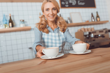 waitress holding cups of coffee