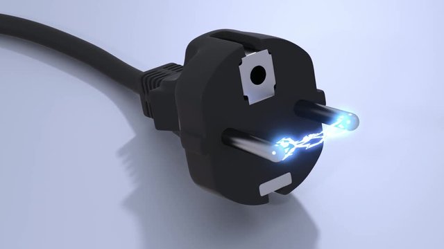 Closeup of a black plug on the ground with a high voltage arc between its pins