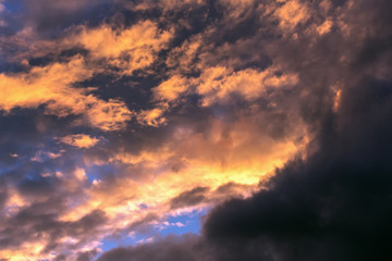 Fototapeta na wymiar Dark-colored storm clouds against the blue sky.