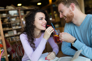 Young students spending time in coffee shop reading books