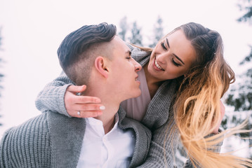 Young pretty pair of lovers. Winter. Date. A pair of lovers on a date in the mountains.