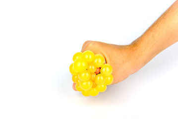 The hand is squeezing the rubber ball.