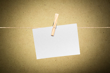 Blank envelope hanging on rope on wooden clothespin