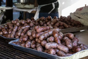 a tray of Tuscan sausages cooked on the grill