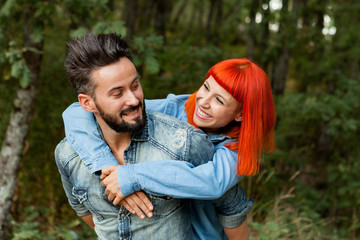 Handsome guy giving piggyback ride to girlfriend
