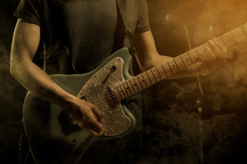Guitarist plays solo.