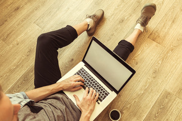 young student works on his laptop at home