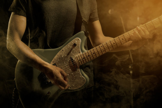 Guitarist plays solo.