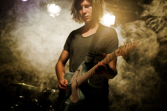 Guitarist plays solo.