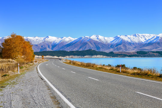 Scenic Road along Lake Tekapo  at beautiful  sunny morning . .Lake Tekapo and mountains with snow in autumn,  Canterbury, South Island, New Zealand.