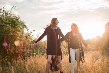 Mother and daughter photographed holding hands