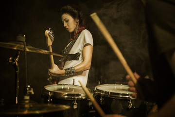Girl-guitar player plays solo.