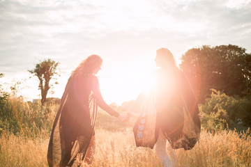 Mother and daughter photographed holding hands