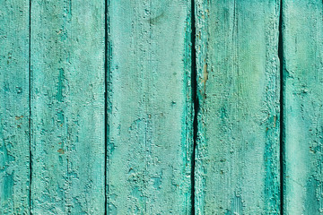 Fototapeta na wymiar Ancient vintage wooden texture. A painted green, blue wall. Cracked paint. Grunge colored background for design. Stock Photo