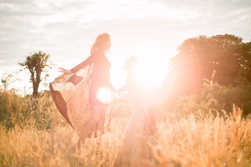 Mom with daughter  walking in the field